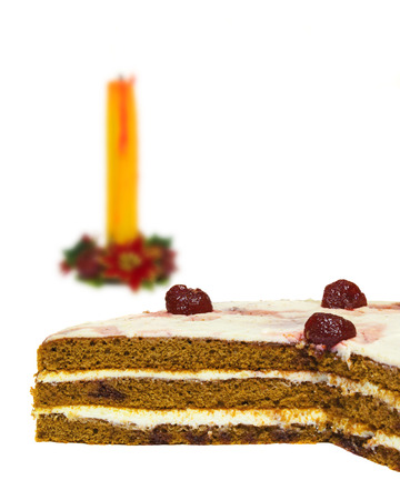 On a white background is clearly visible sponge layer cake. In the background, candle waxの写真素材