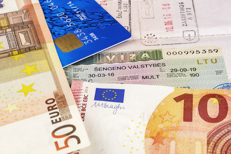 In the Schengen visa in the passport are banknotes and bank cardの写真素材