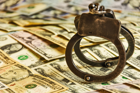 Metal handcuffs on the US currency billsの写真素材