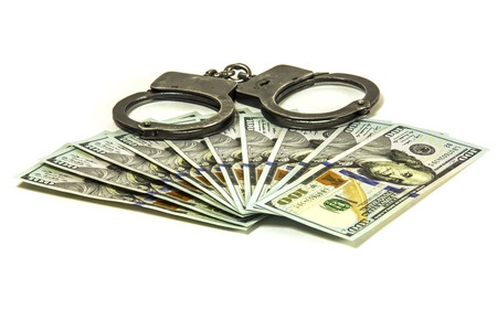 American dollars and metal handcuffs