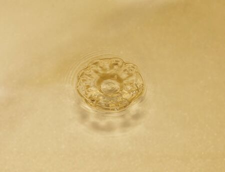 Unevenness in the water from a drop falling from a heightの写真素材