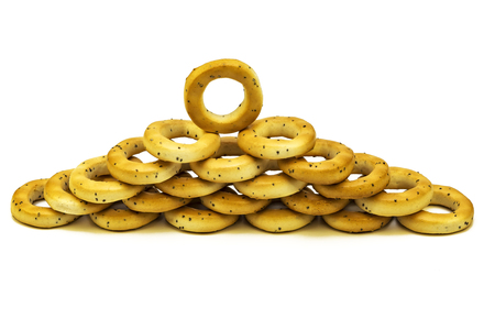On a white background poppy bagels are stacked on each otherの写真素材