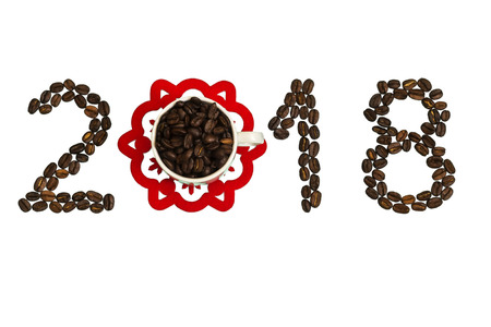 Happy New Year. On a white background, coffee beans are lined with the number 2018 and there is a cup with coffee beans.の写真素材
