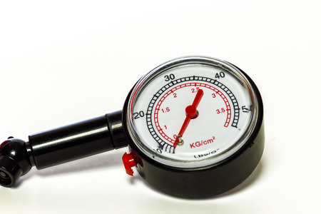 On a white background a close-up of a pressure gauge gauge for measuring tire pressureの写真素材