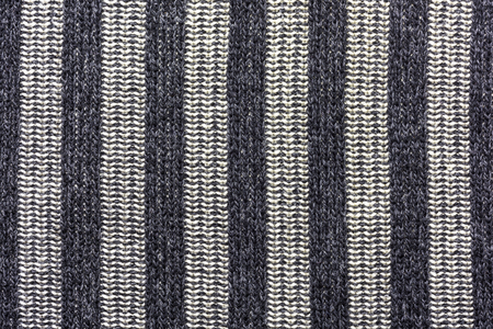 Wool fabric with vertical stripes of black and bright colors, background, textureの写真素材