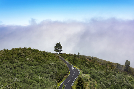 Mountain landscape with thick clouds. Car on a mountain road and thick clouds on the mountainside.
の写真素材