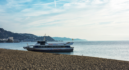Spain, Blanes - September 25, 2017: excursion ship moored on the sandy shoreのeditorial素材