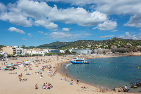 Tossa, Spain - 09/19/2017: city beach and pleasure boat. Stock photo.のeditorial素材