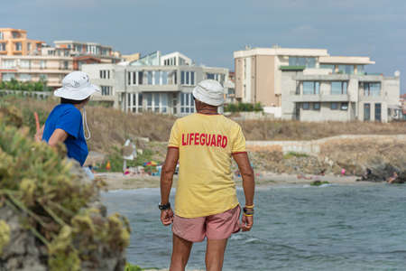 Sozopol, Bulgaria - 09/06/2018: a Man in a t-shirt with the inscription lifeguard. Stock photoのeditorial素材