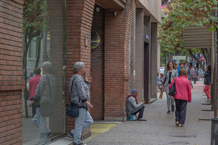 SPAIN, Girona - May 11, 2021: City Street. Passers-by go about their business. Stock Photo