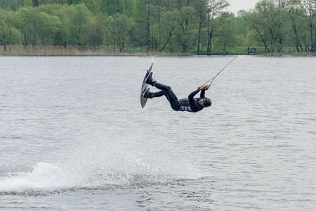Belarus, Minsk - May 16, 2021: Sports. Kitesurfer jumping over the water. Stock photography.のeditorial素材