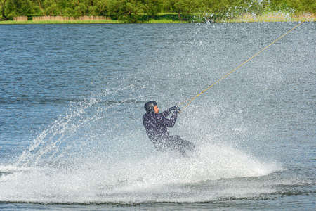 Belarus, Minsk - May 23, 2021: Sports. The kitesurfer splashed down on the surface of the water with large splashes. Stock photography.のeditorial素材