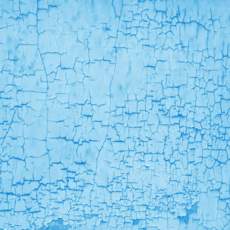 Close-up of the texture of blue peeling plaster. An old plastered wall