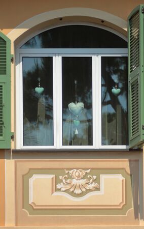open shutters of a loving window for the rays of the sunの写真素材