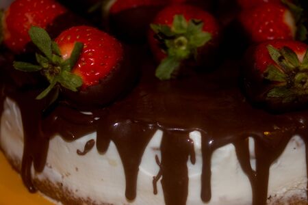 cheese cake with fresh strawberries glazed in dark chocolate.の写真素材