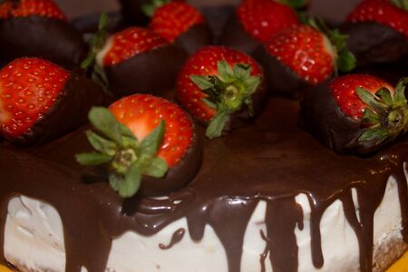 cheese cake with fresh strawberries glazed in dark chocolate.の写真素材