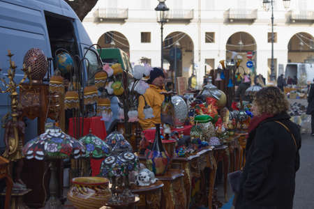 Asti, Italy - Jan 2020: a Caucasian woman looks at an antiques mのeditorial素材