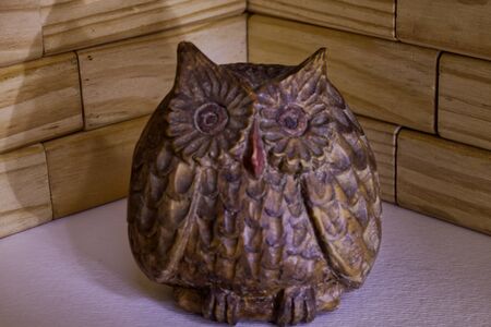 carved wooden owl in a gloomy compositionの写真素材