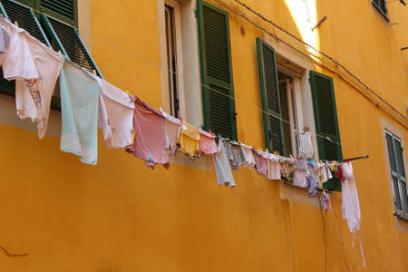 Typical glimpse of the Ligurian alleys: cloths lying outside the balconiesの写真素材
