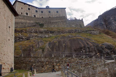 Bard, Italy - february 2020: a family is walking along a paved street during a visit to the fortのeditorial素材