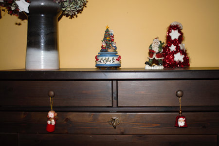 wooden cabinet with Christmas decorations and christmas muggle carouselの写真素材