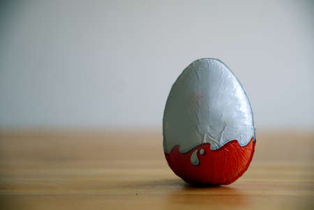 a classic chocolate egg resting on the tableの写真素材