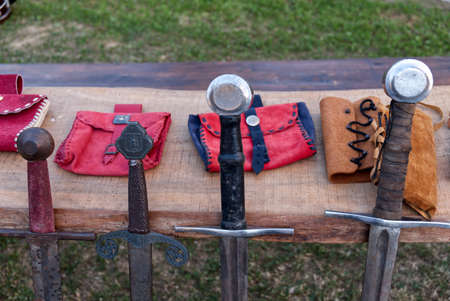 reproductions of medieval swords on display during a historical re enactment in costumeの写真素材