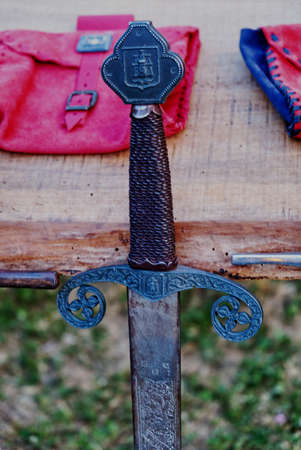 reproduction of medieval sword on display during a historical re enactment in costumeの写真素材