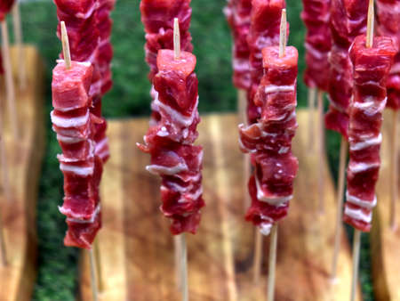 wooden plank with the traditional -arrosticini abbruzzesi-: skewers of sheep meatの写真素材