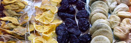 Dried fruit background. Rows of dried dates, apricots, lemon, prunes and figs.