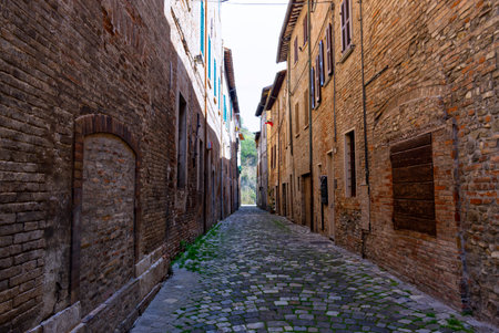 Vertical perspective of narrow medieval cobbled street in middle Italyの写真素材