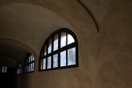 a window as the only light point in a basementの写真素材