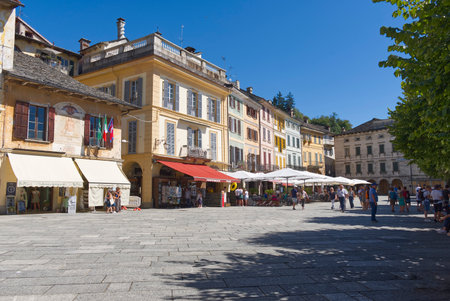 Lago DOrta: Glimpses of the historical center of Orta San Giulio with people and old buildings.