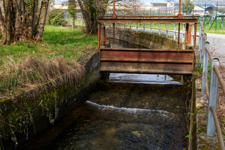 an old sluice in an agricultural irrigation canalの写真素材