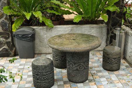 Stone table and stools in garden settingの写真素材