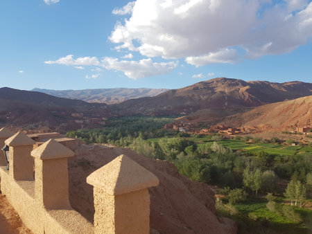 A tower view of a valley with mountains in the backgroundの写真素材