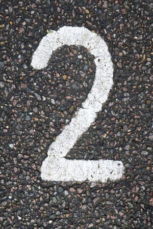 White number two painted on asphaltの写真素材