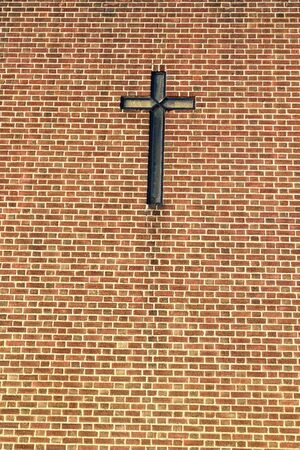 Cross on the wall made of bricksの写真素材