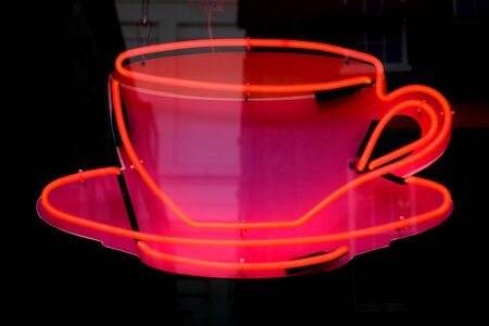 Red neon lighting equipment in shape of cup for coffeeの写真素材