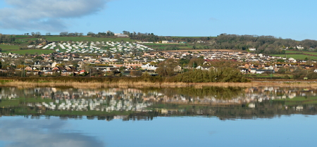 Seaton reflected on the water of river Axe in Devonの写真素材