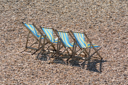 Beach chairs on the pebbles on the Jurassic Coast in Devon