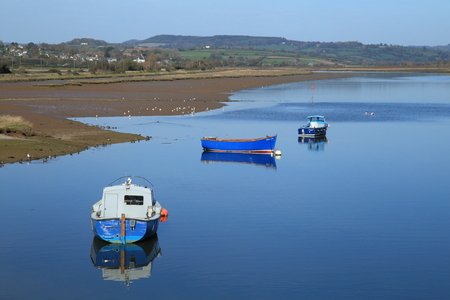 Boats on the river Axe estuary near Seaton in Devonのeditorial素材