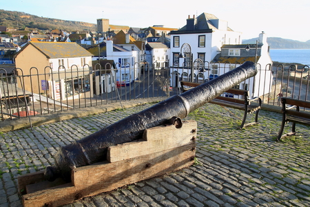 Old cannon in town of Lyme Regis overlooking Cobb Gate on Jurassic Coast in Dorset, Englandのeditorial素材