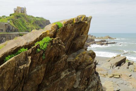 Rocks on the beach during low tide in seaside town of Ilfracombe on the North Devon coastの写真素材