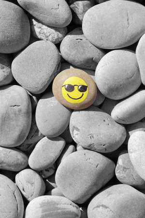 Smiley face painted on the stoneの写真素材