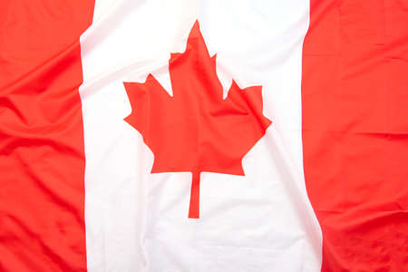 Real fabric flag of Canada as background or texture, top view, Canadian flag