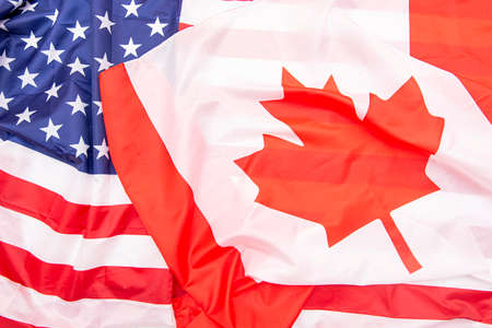 Natural fabric Canada and USA flags as background, Canadian and American flags, top viewの写真素材
