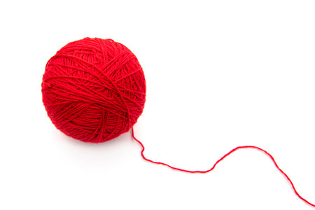 Red ball with woolen threads isolated on white backgroundの写真素材