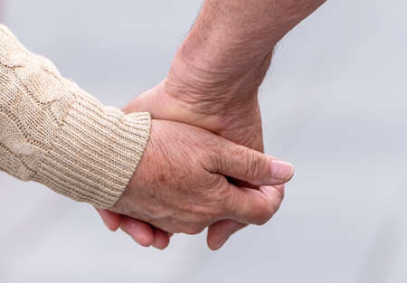 Elderly Couple hands of elderly couple walking in a Street