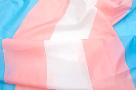 Transgender fabric flag with white, pink, blue strips. Close-up transgender pride flag as background or textureの写真素材